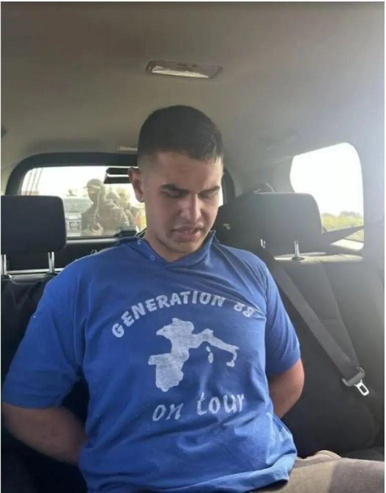 Uroš Blažić after his arrest, wearing a pro-Nazi shirt.