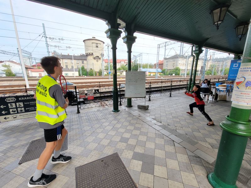 Liam Krol playing badminton with a young refugee from Ukraine.